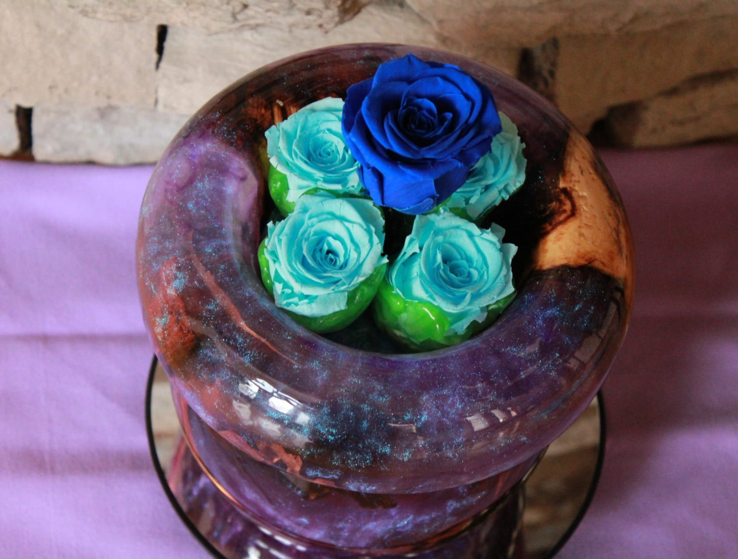 Purple vase with preserved roses