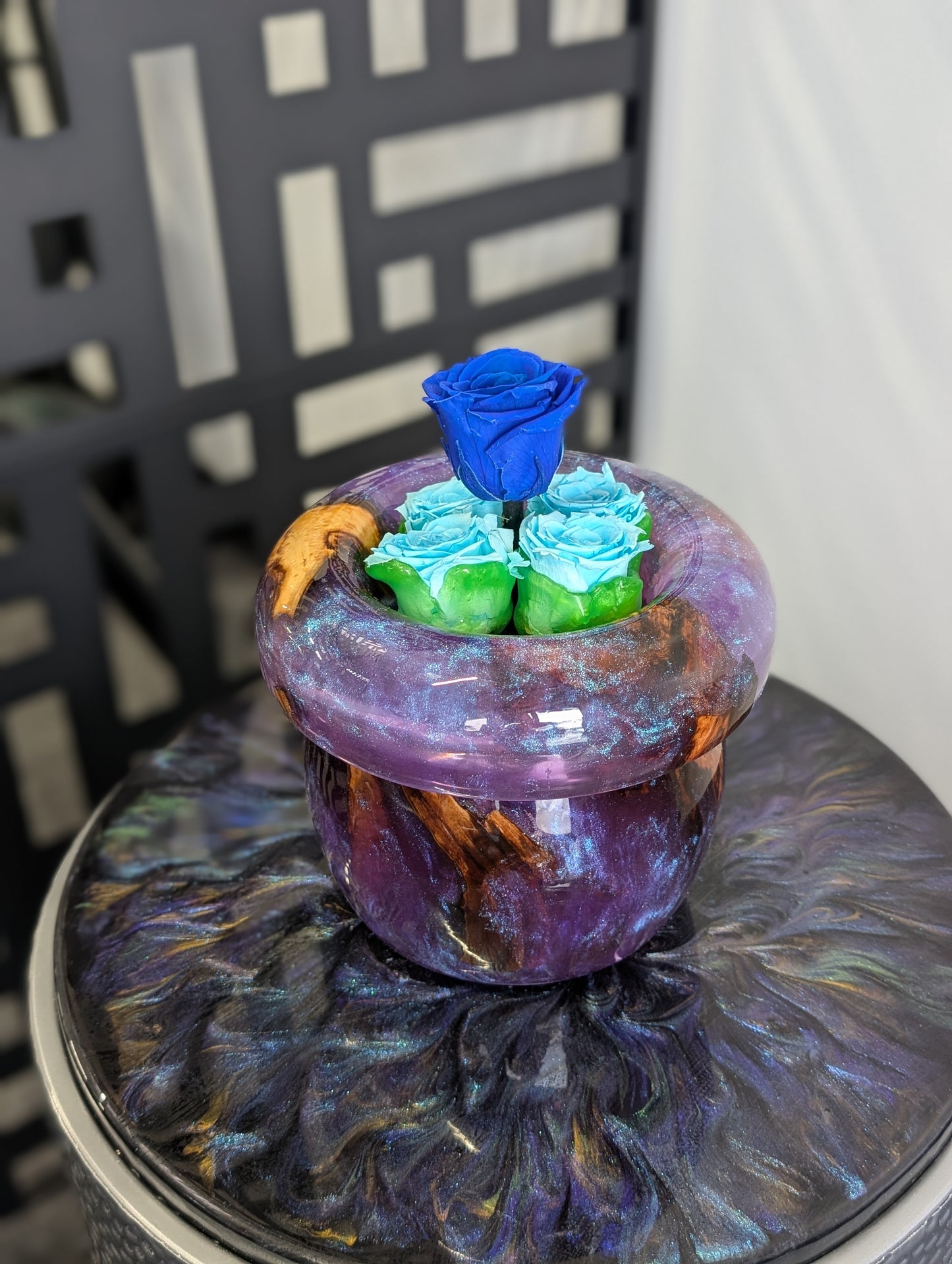 Purple vase with preserved roses