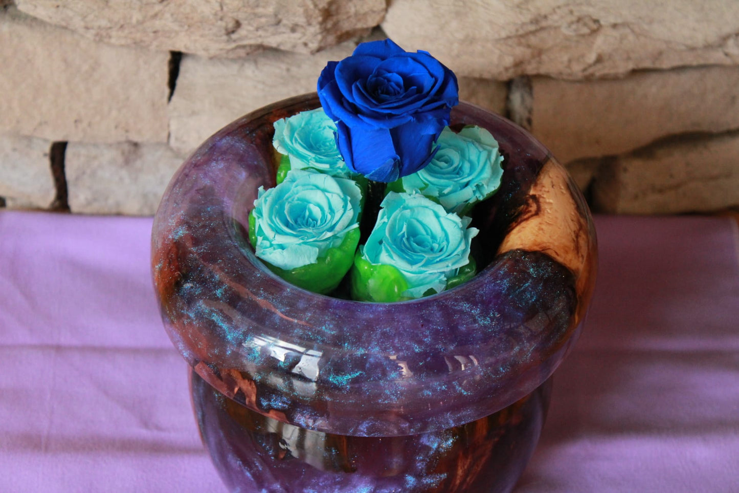 Purple vase with preserved roses