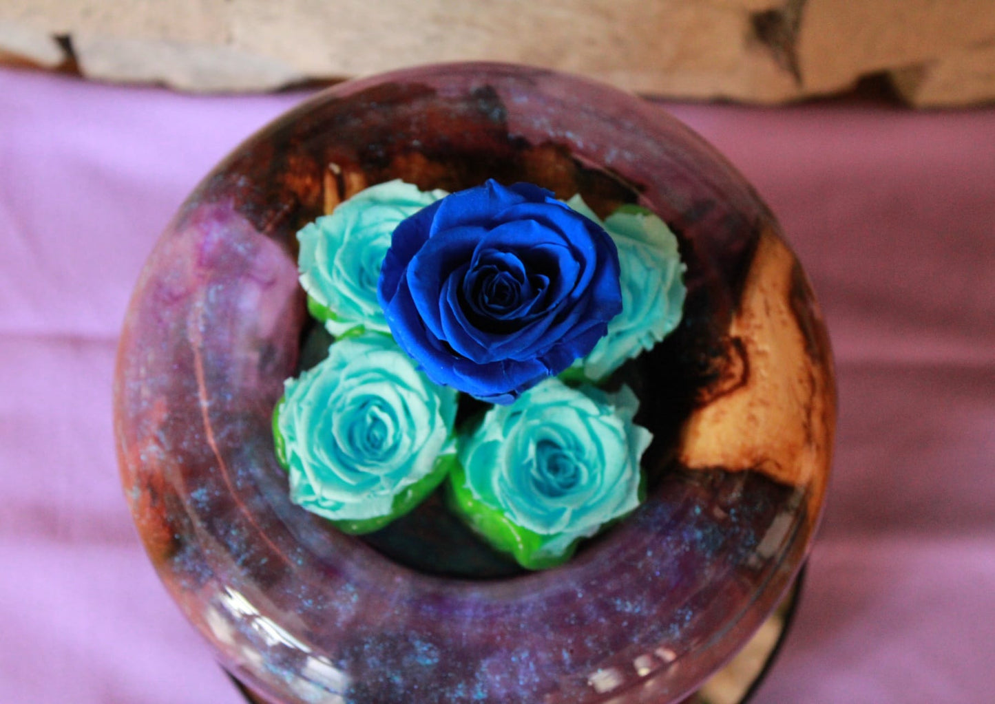 Purple vase with preserved roses
