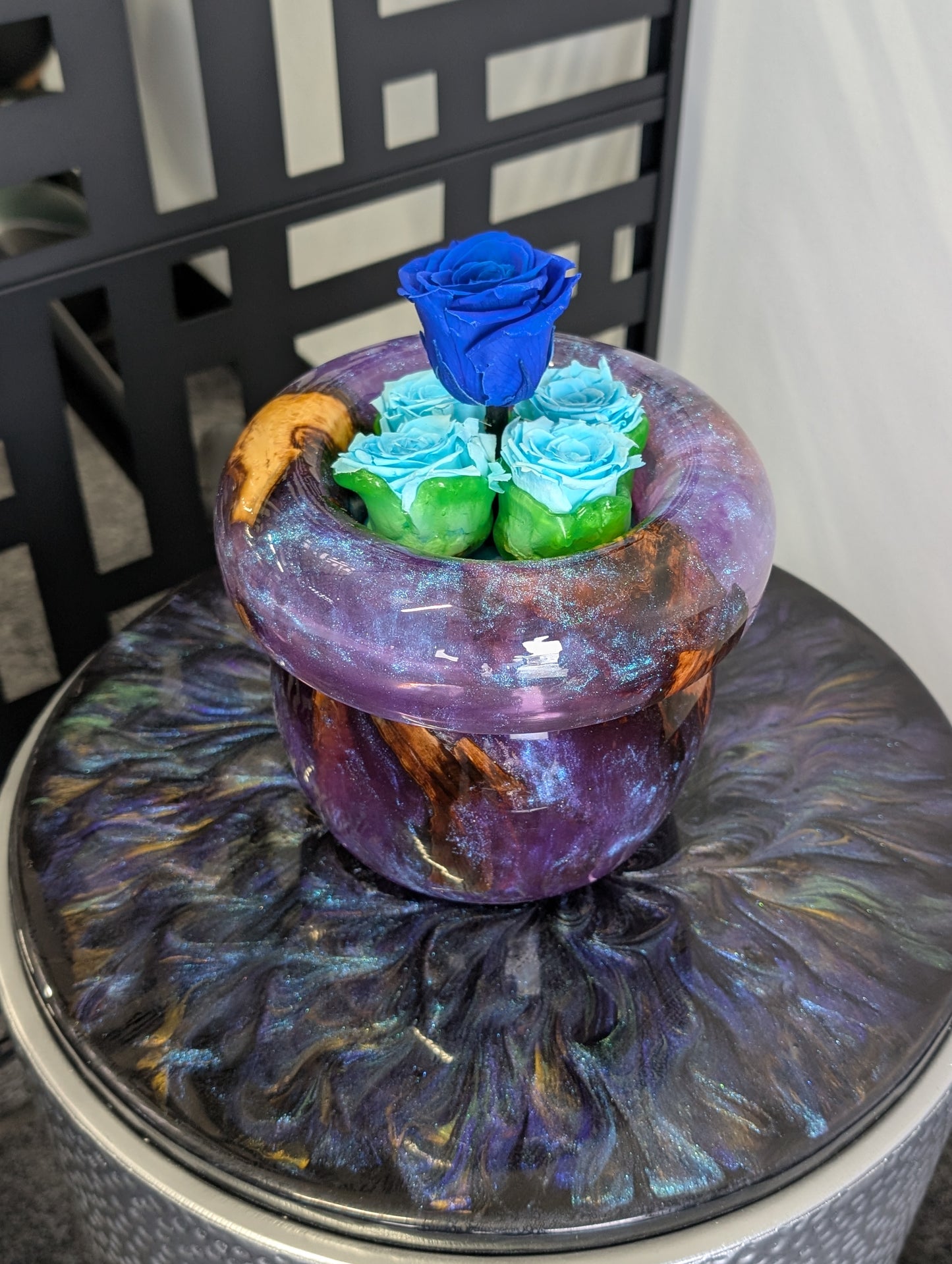 Purple vase with preserved roses