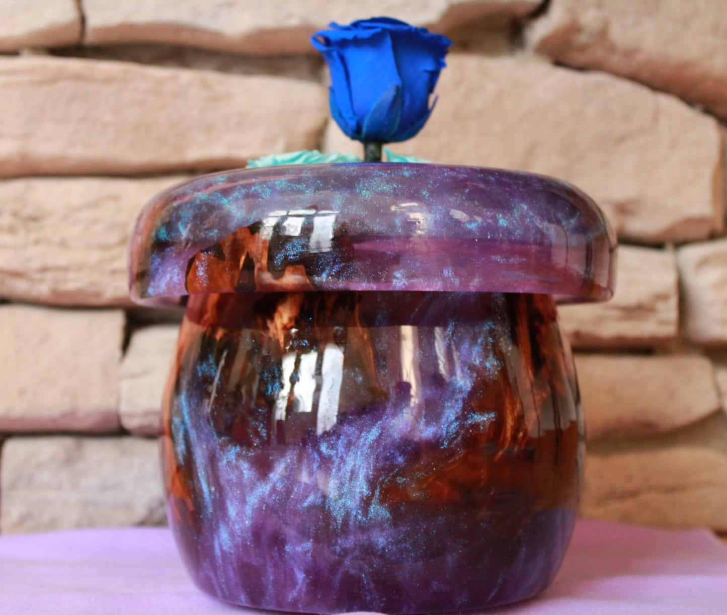 Purple vase with preserved roses